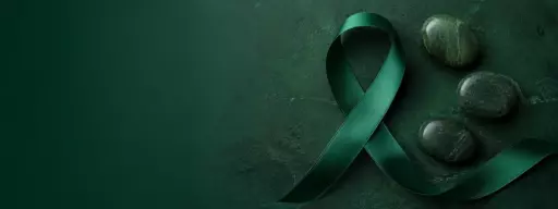 Green awareness ribbon on a dark green textured background.